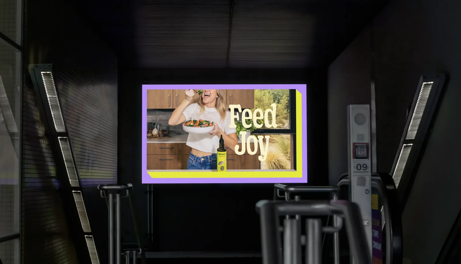 A Feed Joy panel on a subway platform, the cook in her kitchen