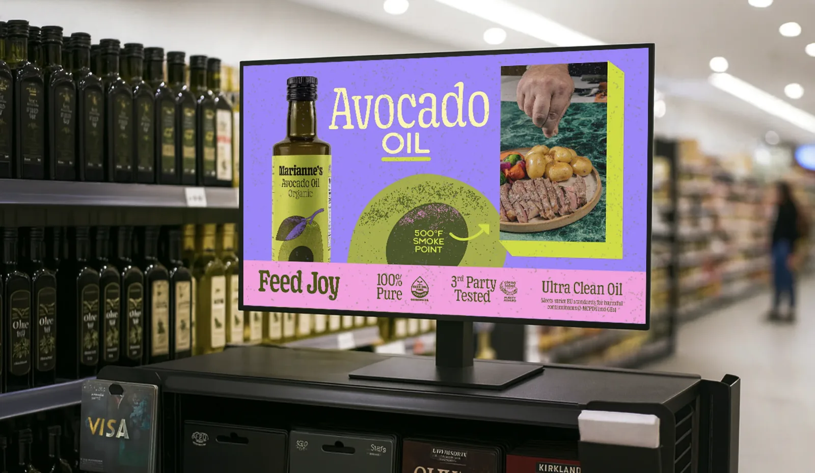 An in-store screen above the oil shelf: Avocado Oil, 500 degree smoke point, ultra clean oil