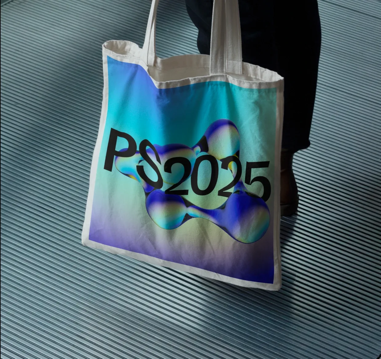 A canvas tote printed edge to edge with PS2025 through a blue and green molecule
