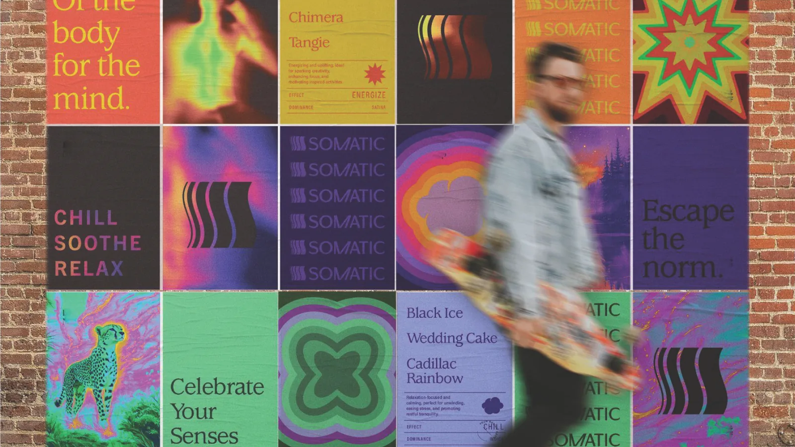 A wall of Somatic posters on a brick block: Of the body for the mind, Chill Soothe Relax, Escape the norm, Celebrate Your Senses, a skater walking past